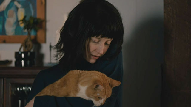 Nancy - Andrea Riseborough holding ginger and white tabby cat Paul