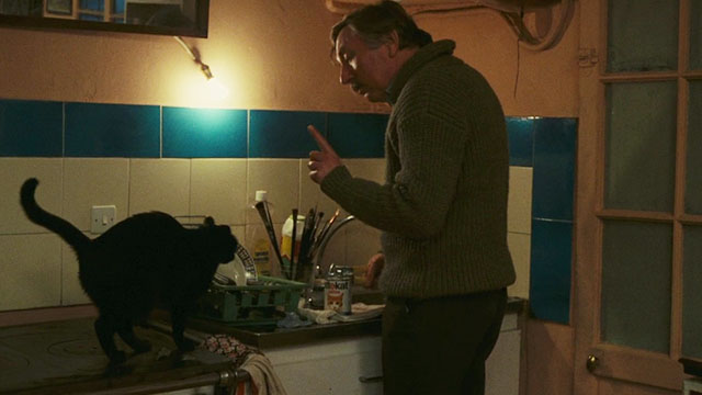 Neige - black cat sitting on counter waiting for dinner from Bruno Paul La Person