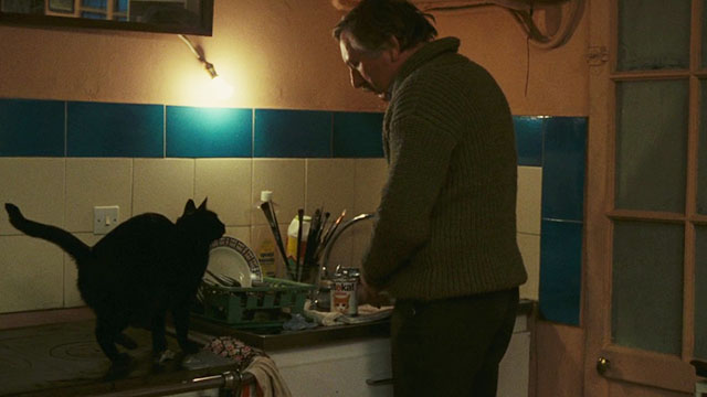 Neige - black cat sitting on counter waiting for dinner from Bruno Paul La Person