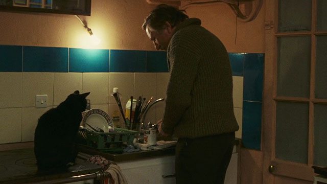 Neige - black cat sitting on counter waiting for dinner from Bruno Paul La Person