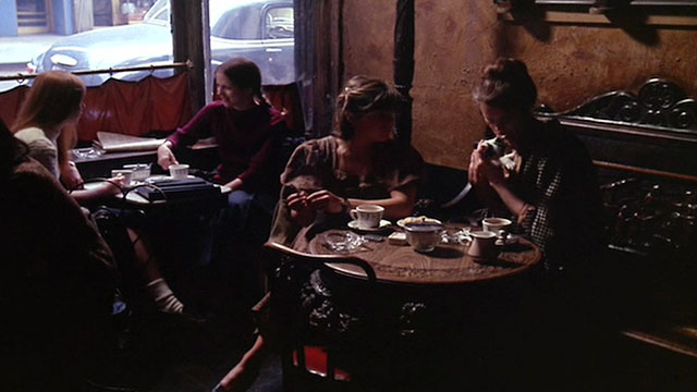 Next Stop, Greenwich Village - Anita Lois Smith holding white and black cat in coffee shop with Connie Dori Brenner