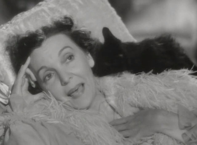 Niagara Falls - Emmy Zasu Pitts lying on lounge chair with black cat licking her face