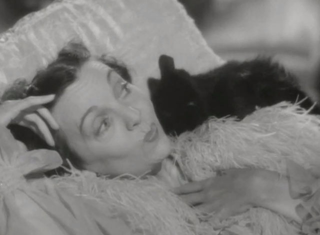 Niagara Falls - Emmy Zasu Pitts lying on lounge chair with black cat licking her face