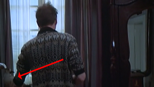 The Night Porter - Siamese cat on table behind Max Dirk Bogarde