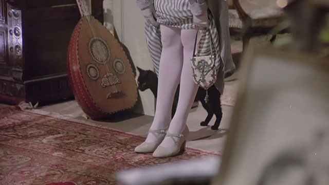 Nijinsky - black cat behind Romola's legs
