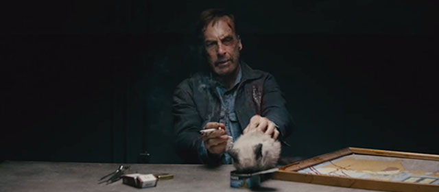 Nobody - Hutch Mansell Bob Odenkirk with tiny seal point Siamese kitten on table