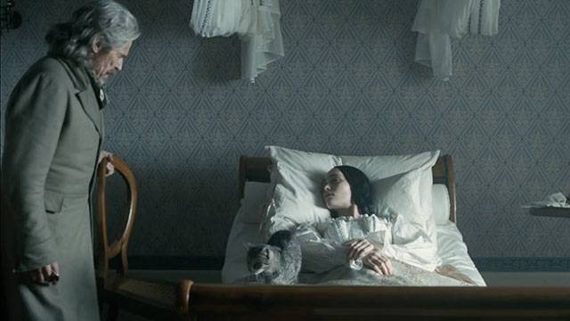 Nosferatu - Ellen Lily-Rose Depp lying on bed with silver tabby cat Greta and Professor von Franz Willem Defoe