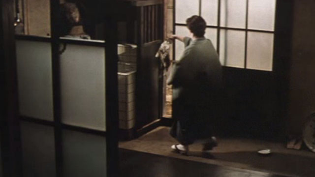 Babe - Ikuko Machiko Ky&ocirc; carrying tabby kitten by scruff to doorway