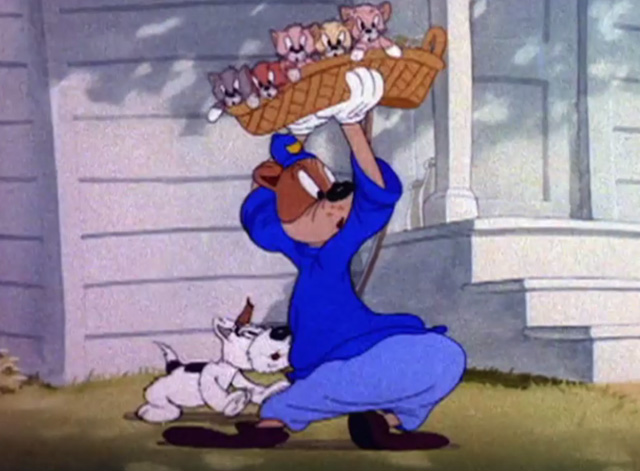 Officer Pooch - Officer Pooch holding basket of kittens on his head to keep them away from terrier
