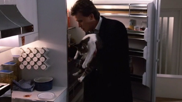 Of Unknown Origin - Bart Peter Weller holding tabby and white cat in kitchen