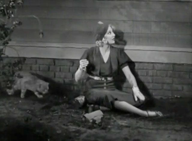 The Old Bull - Thelma Todd sitting on ground outside window with tabby cat approaching