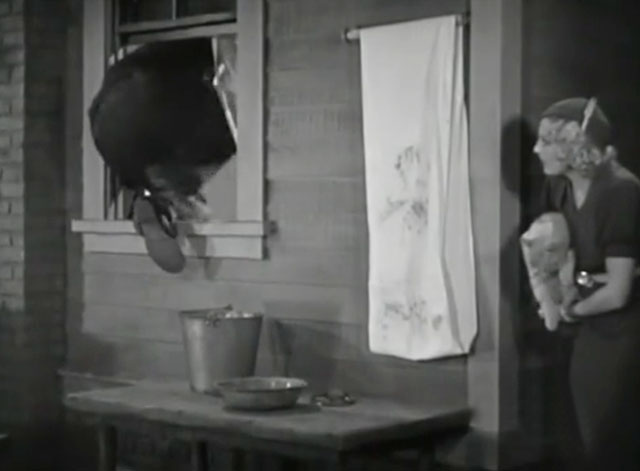 The Old Bull - Thelma Todd holding tabby cat as man climbs out window