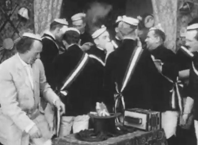 Ole Heidelberg - drunk prefect spotting tabby kitten in top hat with other male students