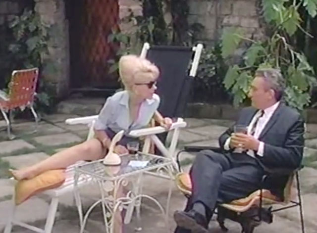 The Omegans - seal point Siamese cat under chair with Valdemar Lucien Pan and Linda Ingrid Pitt 