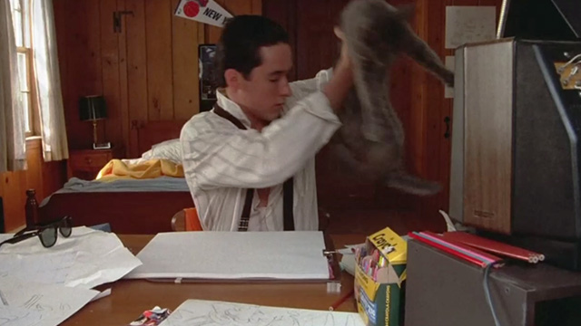 One Crazy Summer - long hair gray cat Morty being lifted off desk by Hoops McCann John Cusack