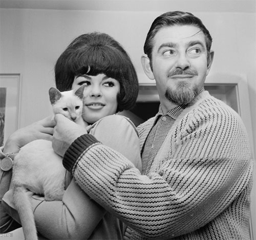 Harrison Marks with fiancee Vivianne Warren holding Siamese cat