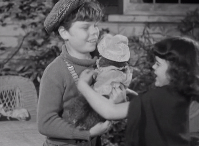 Our Gang - Practical Jokers - Tommy Butch Bond hands Darla Hood her tabby cat wearing baby clothes back