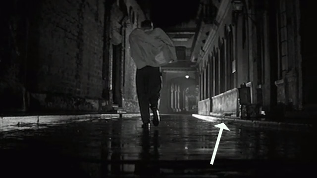 Our Man in Havana - cat running onto curb in background behind Wormold Alec Guinness