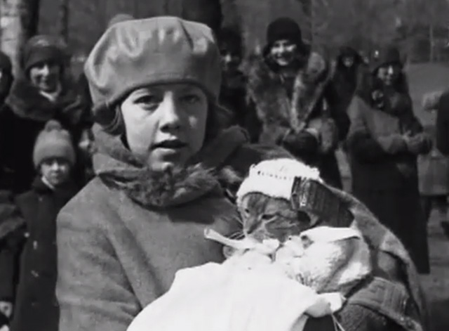 Pets! A Canadian Cameo - tabby cat in knitted baby clothes with girl owner