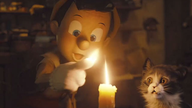 Pinocchio - black and white tuxedo kitten Figaro watching as Pinocchio sets his finger on fire