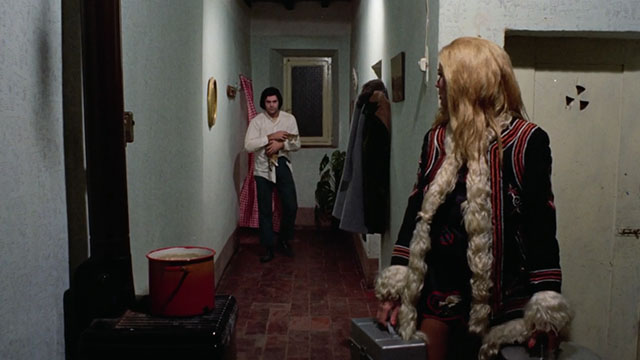 The Police Are Blundering in the Dark - La polizia brancola nel buio - man holding calico tabby cat in hallway looking at Enrichetta Blond Margaret Rose Keil