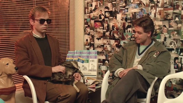 Proof - limp Bengal tabby cat Ugly being held by Martin Hugo Weaving in veterinary waiting room with Andy Russell Crowe