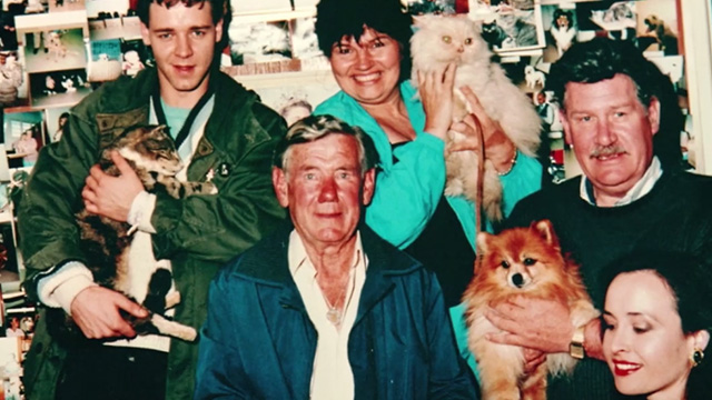 Proof - photo of limp Bengal tabby cat Ugly being held by Andy Russell Crowe with other people and pets