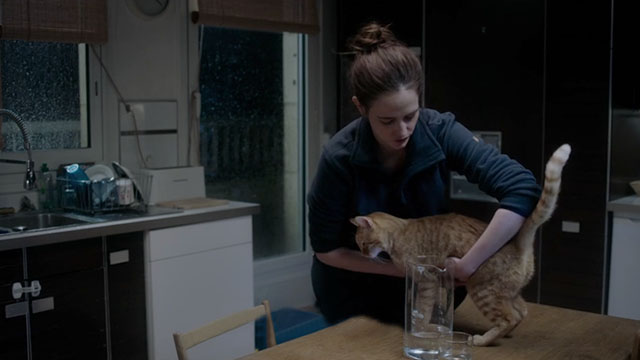 Proxima - Sarah Eva Green picking up ginger tabby cat Laika from table