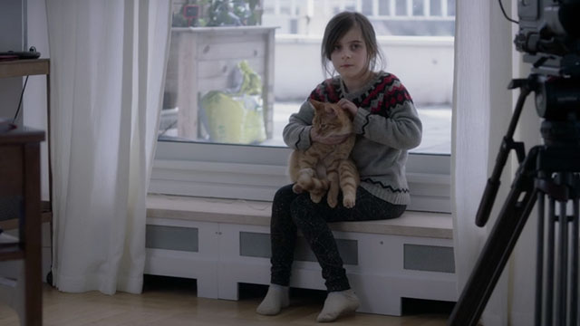 Proxima - Stella Zélie Boulant holding ginger tabby cat Laika on lap