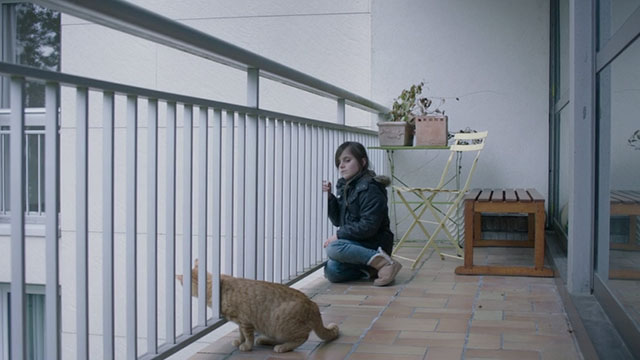 Proxima - Stella Zélie Boulant with ginger tabby cat Laika on patio