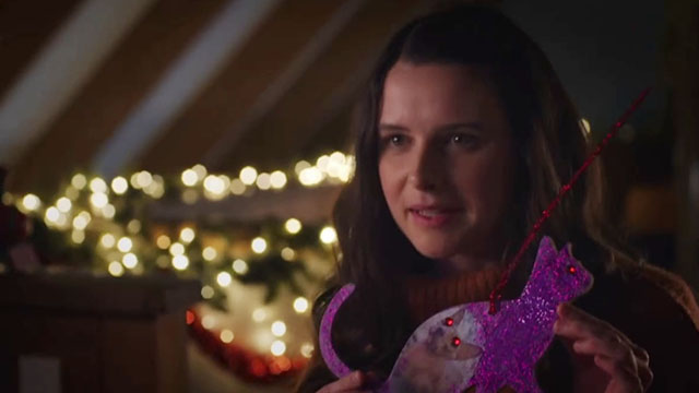 Puppy Love for Christmas - Annie Georgia Flood holding up ornament with photo of hairless Sphynx cat Bigglesworth