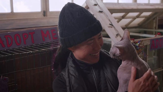 Puppy Love for Christmas - Stacy Ling Cooper Tang holding hairless Sphynx cat Bigglesworth