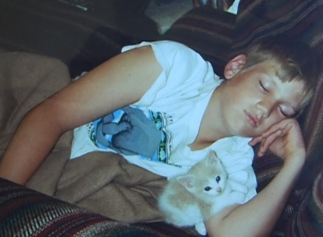 Ramblin' Freak - Parker Smith as boy lying with orange and white kitten