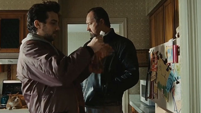 Real Time - Andy Jay Baruchel and Reuben Randy Quaid in kitchen with ginger and white tabby cat on stove