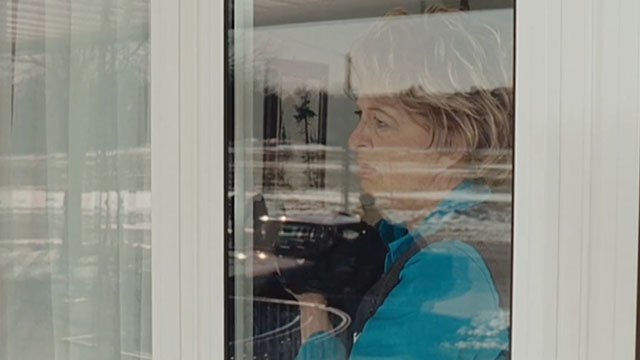 Real Time - grandma Jayne Eastwood holding black cat while looking out window