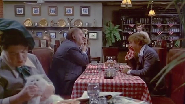Rhinoceros - woman Anne Ramsey sitting with longhaired white cat at table in front of John Zero Mostel and Stanley Gene Wilder