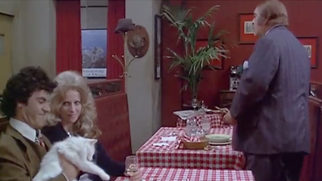 Rhinoceros - Robert Fields and Melody Santangello sitting with longhaired white cat at table in front of John Zero Mostel