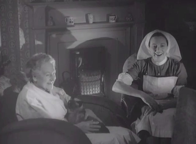Rogue's Yarn - Siamese cat Khadi sitting in lap of cook Madoline Thomas with nurse Joan Carol
