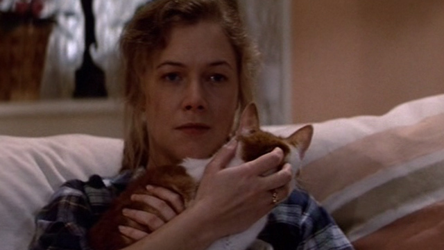Romancing the Stone - Joan Wilder Kathleen Turner holding orange and white cat Romeo