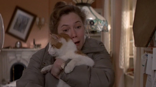 Romancing the Stone - Joan Wilder Kathleen Turner hugging orange and white cat Romeo
