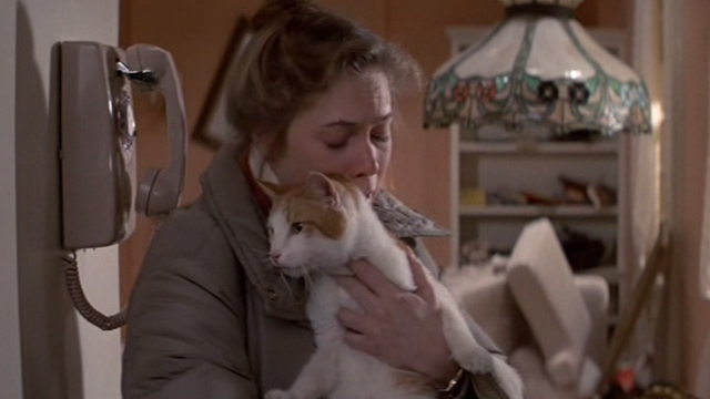 Romancing the Stone - Joan Wilder Kathleen Turner relieved to be holding orange and white cat Romeo