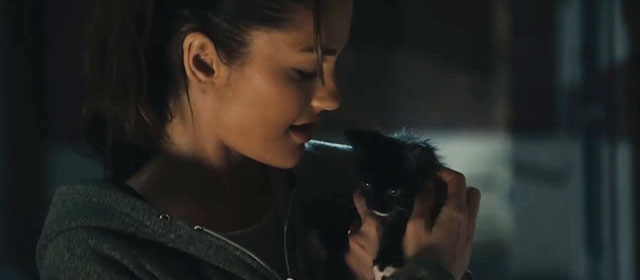 The Roommate - Sara Minka Kelly holding tuxedo kitten Cuddles