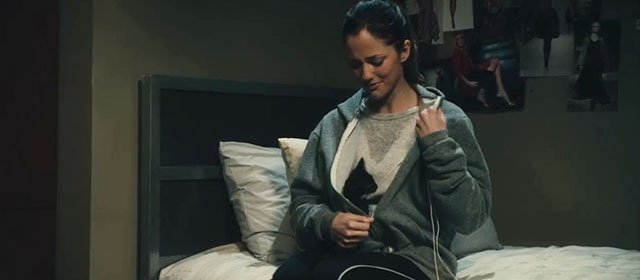 The Roommate - Sara Minka Kelly unzipping jacket to reveal tuxedo kitten Cuddles