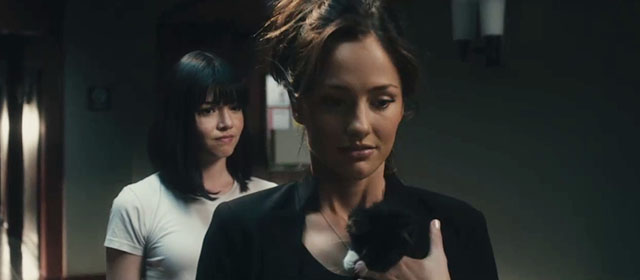 The Roommate - Sara Minka Kelly holding tuxedo kitten Cuddles with resident assistant Jennifer Cadena