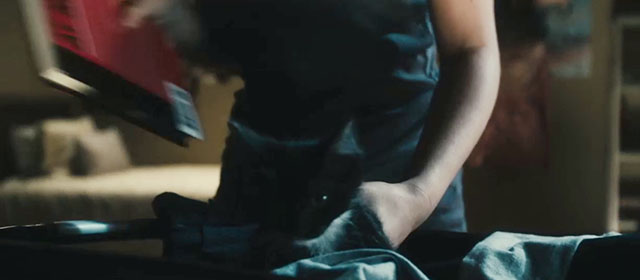 The Roommate - tuxedo kitten Cuddles being placed in laundry basket