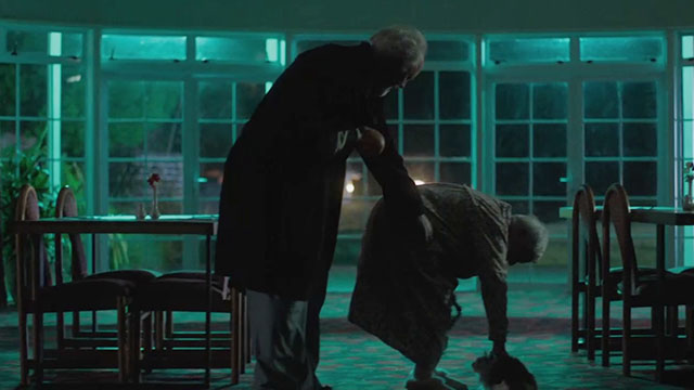 The Rule of Jenny Pen - Crealy John Lithgow approaching Eunice Hillary Norris petting longhair calico cat Pluto Marbles