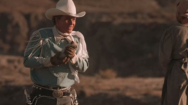 Rustler's Rhapsody - Rex Tom Berenger holding small Siamese kitten