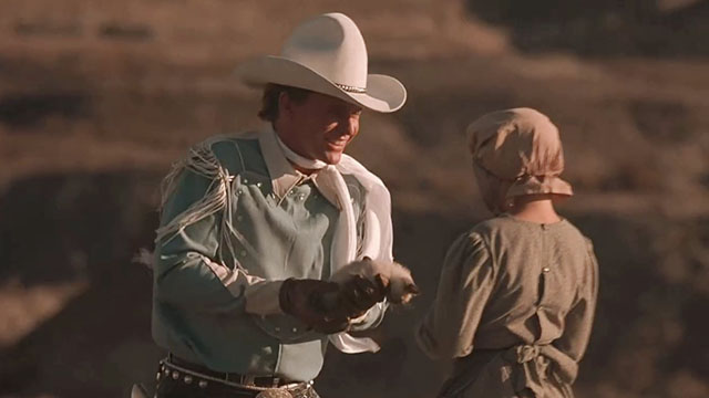 Rustler's Rhapsody - Rex Tom Berenger holding small Siamese kitten