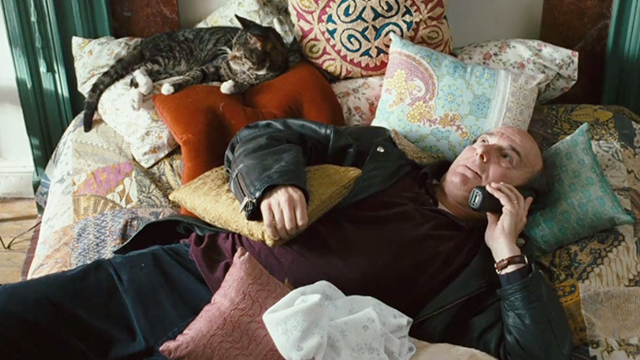 The Savages - tabby cat Genghis lying on bed with Larry Peter Friedman