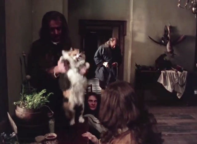 Schalcken the Painter - students forcing longhair calico cat to dance on table